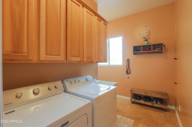 washroom featuring light tile patterned flooring, cabinets, independent washer and dryer, and sink