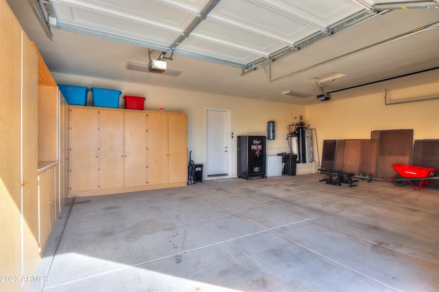 garage with a garage door opener and water heater