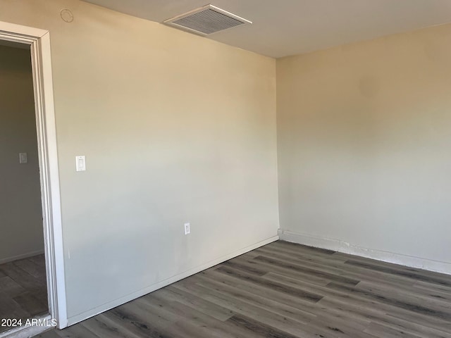 spare room with dark wood-type flooring