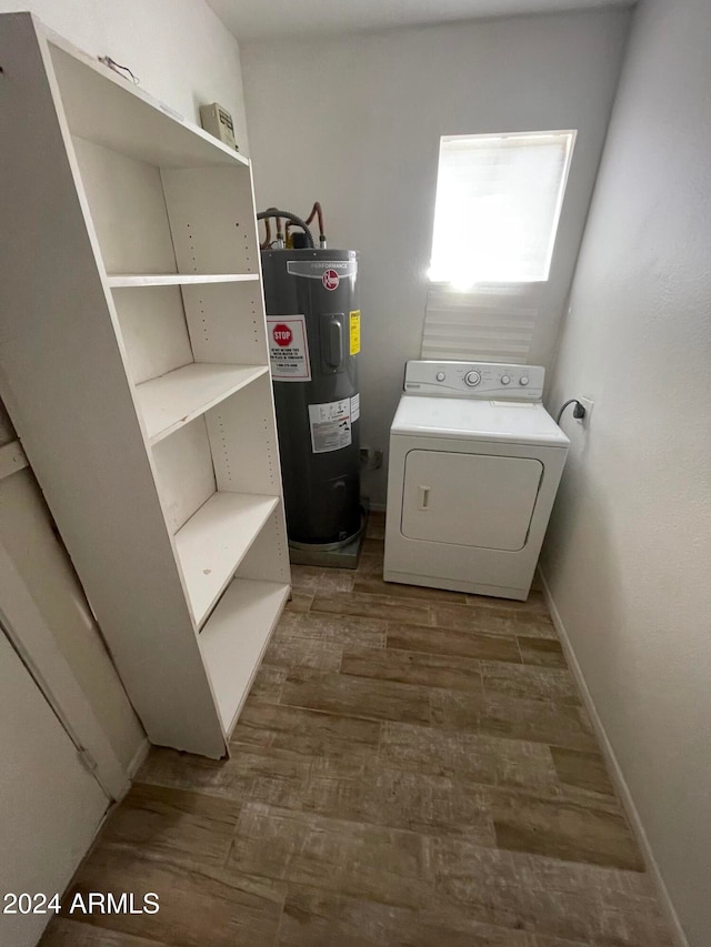 laundry room with electric water heater, wood-type flooring, and washer / clothes dryer