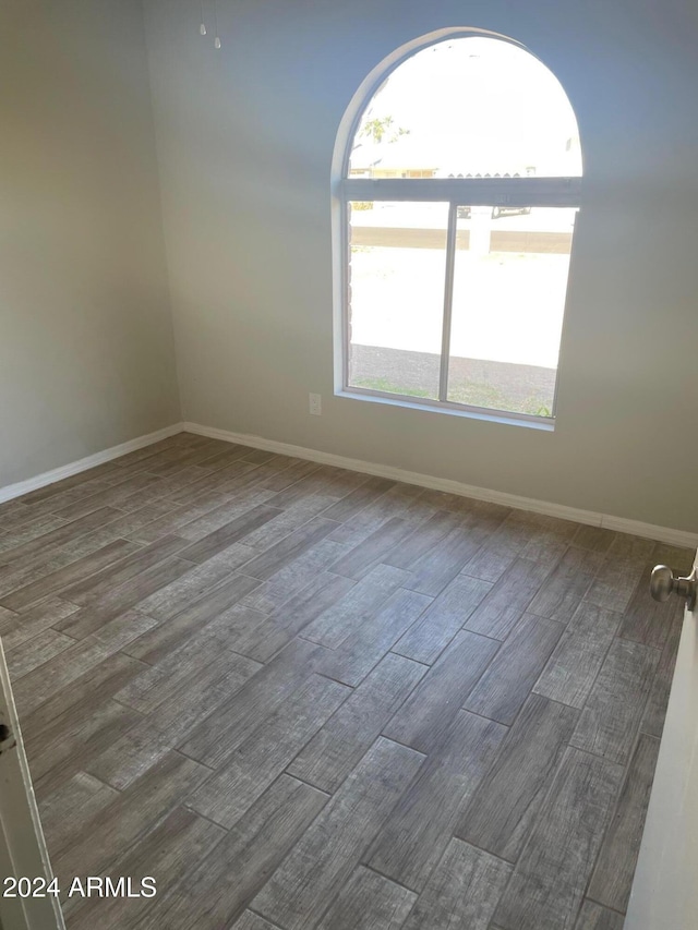 empty room with dark hardwood / wood-style flooring