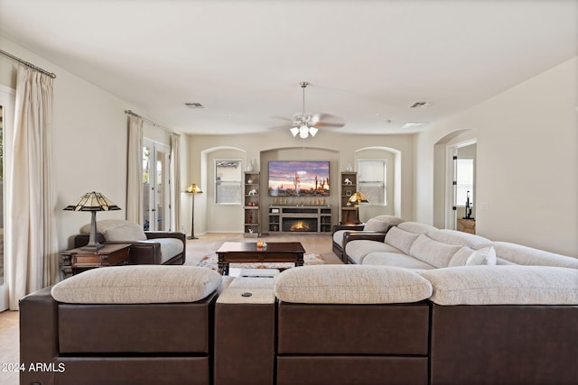 carpeted living room featuring ceiling fan