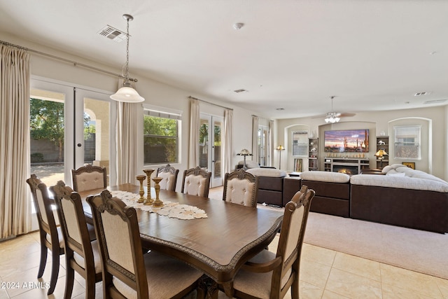 tiled dining room featuring french doors and ceiling fan