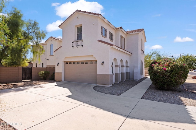 mediterranean / spanish home featuring a garage