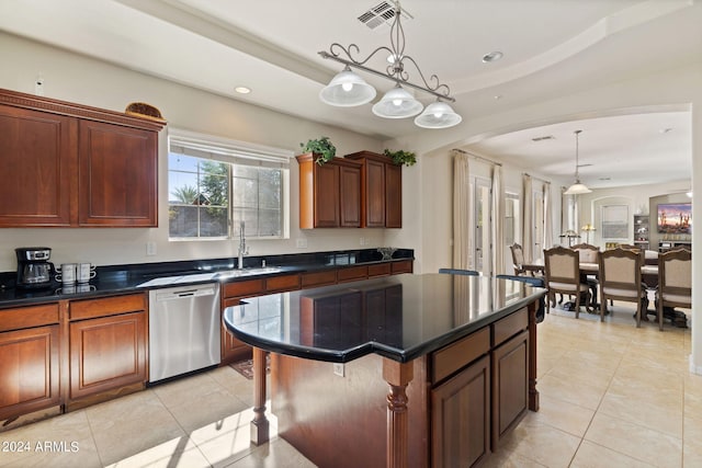 kitchen featuring pendant lighting, sink, stainless steel dishwasher, and a kitchen island