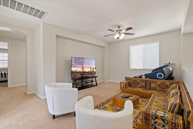 living room featuring light carpet and ceiling fan