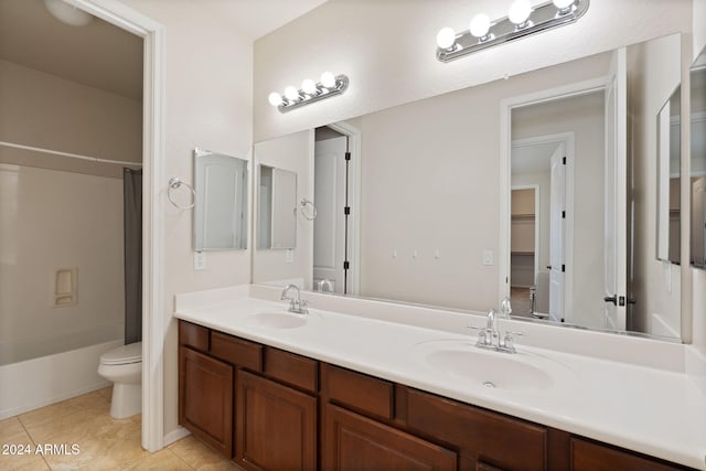 full bathroom featuring vanity, shower / bath combination with curtain, toilet, and tile patterned flooring