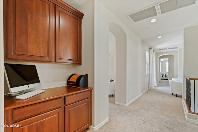 carpeted office featuring vaulted ceiling