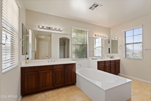 bathroom featuring vanity, tile patterned floors, and separate shower and tub