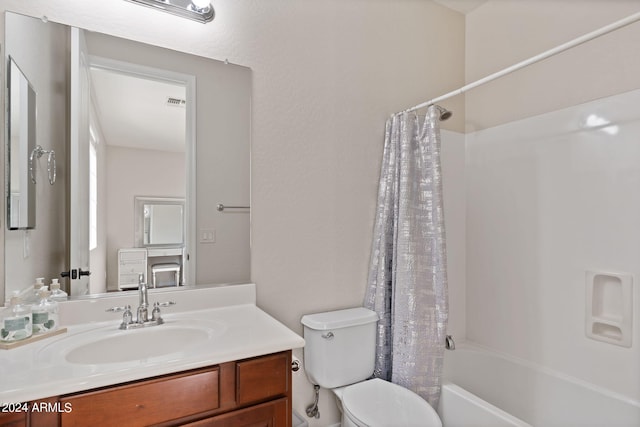 full bathroom featuring vanity, shower / bath combination with curtain, and toilet