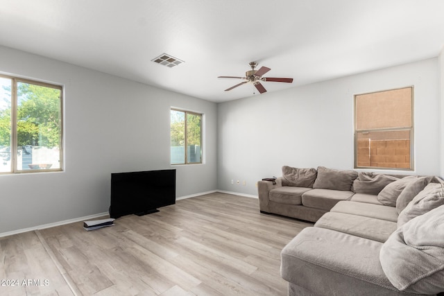 living room with light hardwood / wood-style floors and ceiling fan