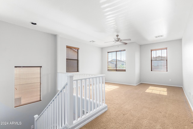 corridor featuring light colored carpet