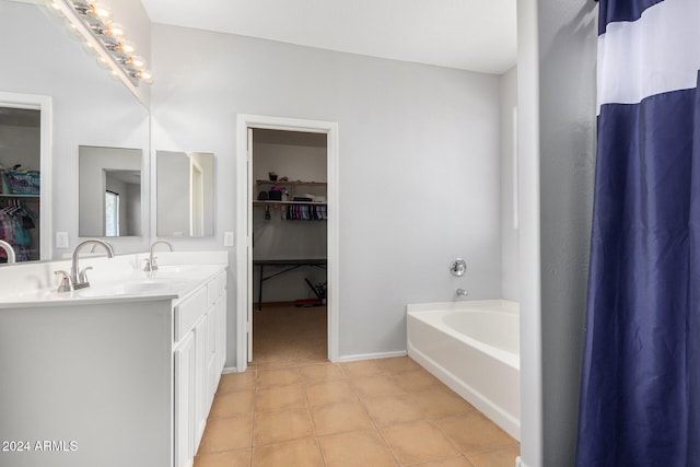 bathroom featuring vanity, a tub, and tile patterned floors