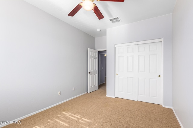 unfurnished bedroom featuring a closet, carpet flooring, and ceiling fan