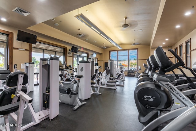 gym featuring ceiling fan and lofted ceiling