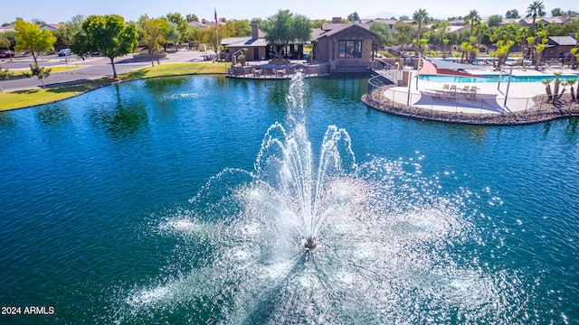 view of swimming pool with a water view