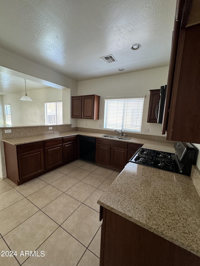 kitchen featuring black appliances, decorative light fixtures, plenty of natural light, and sink