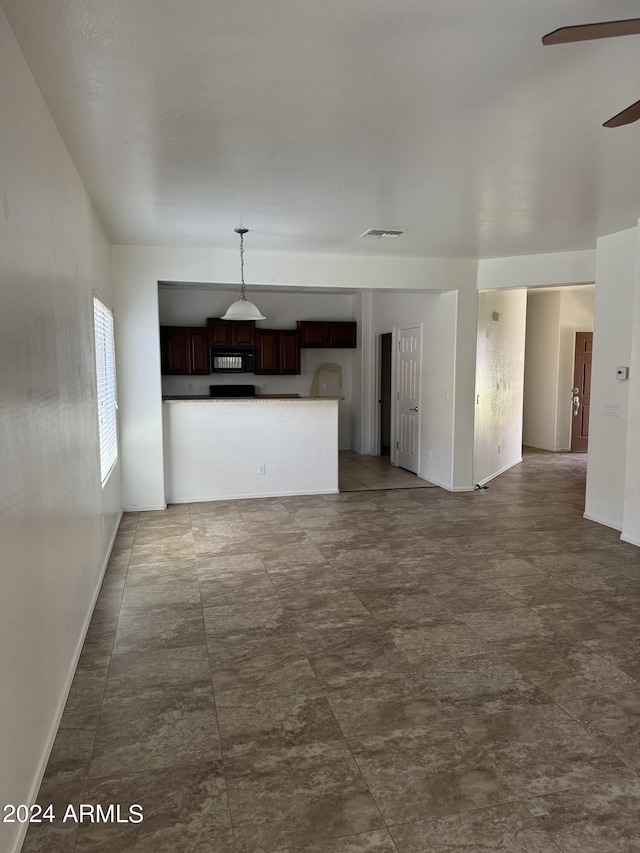 unfurnished living room featuring ceiling fan