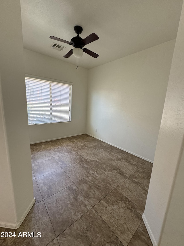 tiled empty room with ceiling fan