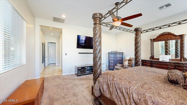 bedroom with ceiling fan and light carpet