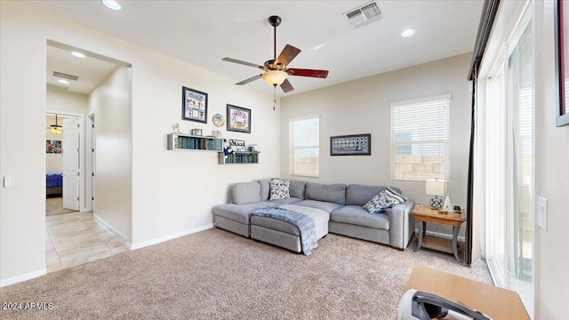 carpeted living room featuring ceiling fan