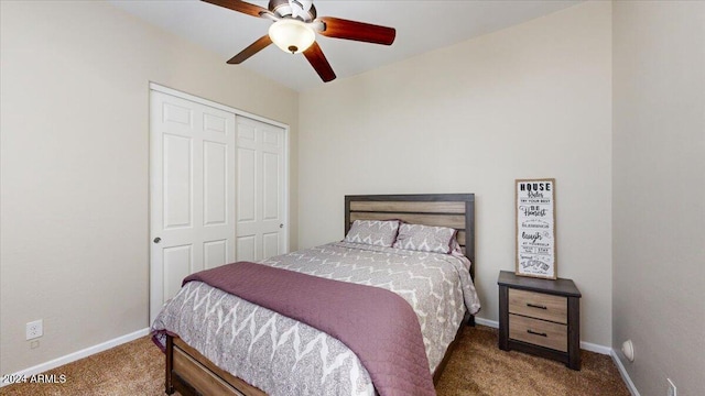 carpeted bedroom featuring ceiling fan and a closet