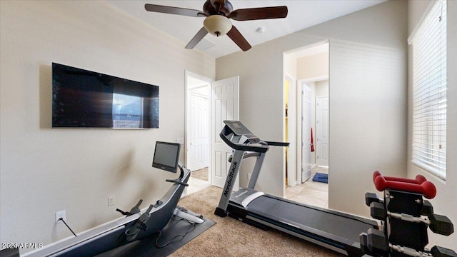 workout area with ceiling fan and light colored carpet