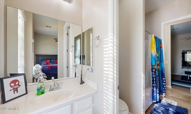 bathroom with ceiling fan, vanity, and toilet