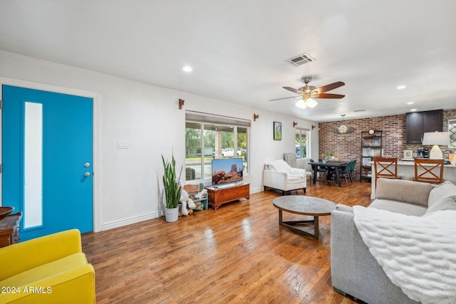 living room featuring ceiling fan and light hardwood / wood-style floors