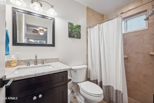 bathroom with ceiling fan, vanity, toilet, and curtained shower