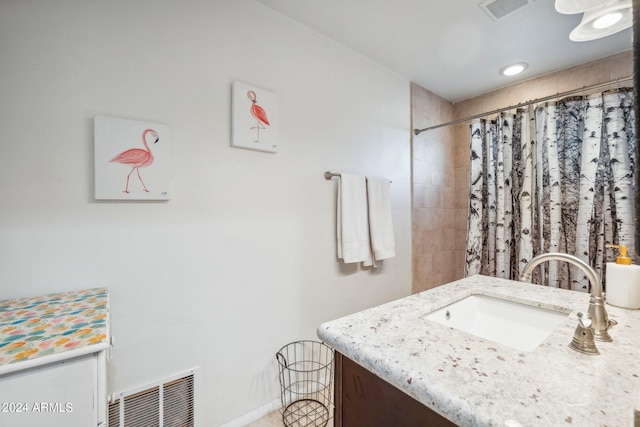 bathroom featuring vanity and curtained shower