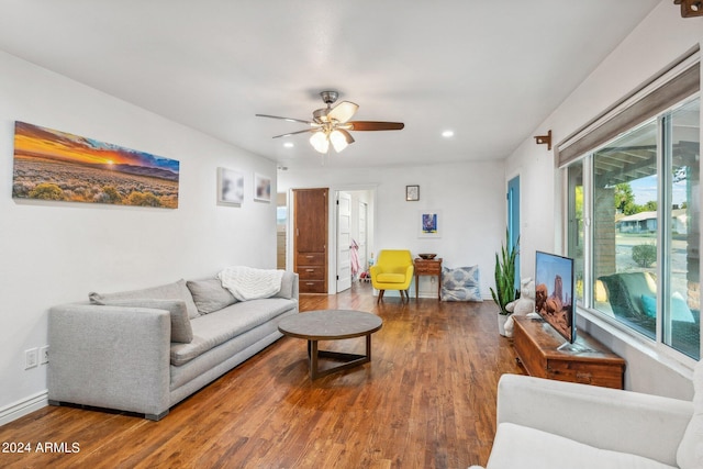 living room with wood-type flooring and ceiling fan