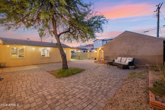 patio terrace at dusk featuring outdoor lounge area