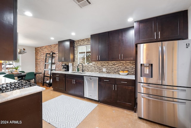 kitchen featuring stainless steel appliances, decorative backsplash, dark brown cabinetry, and sink