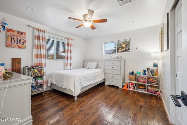 bedroom with dark hardwood / wood-style flooring and ceiling fan