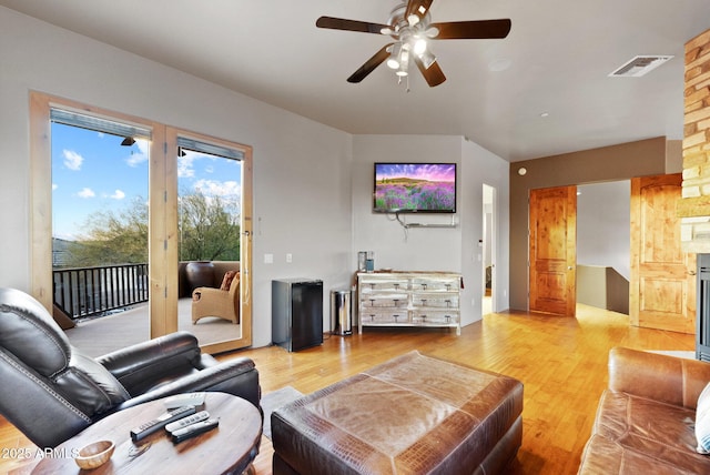 living room with ceiling fan and light wood-type flooring