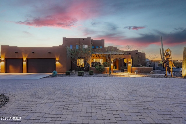 pueblo-style home with a garage