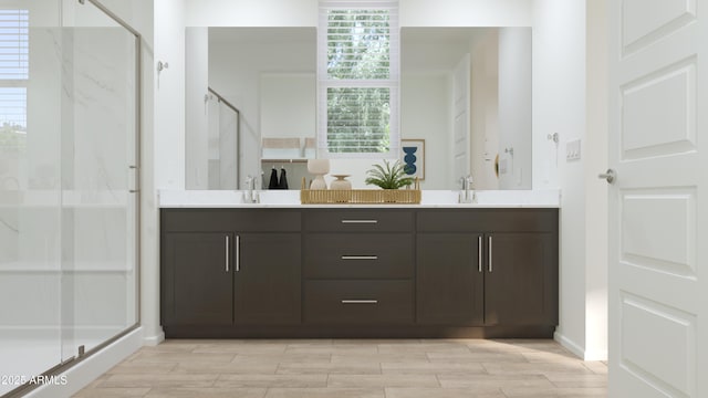 bathroom with double vanity, a sink, wood finished floors, and a shower stall