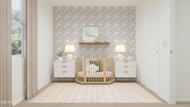 bedroom featuring baseboards and a nursery area