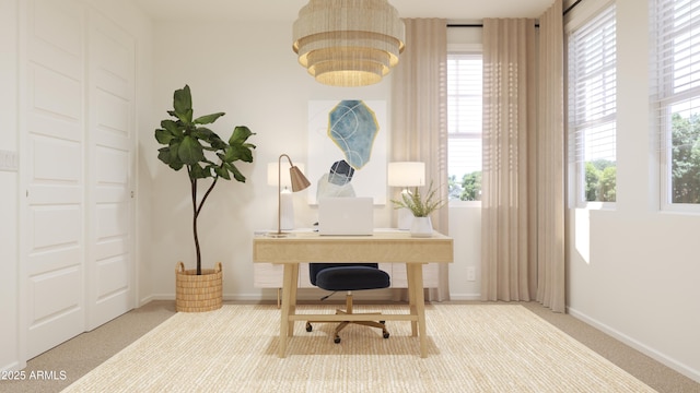 office area with baseboards, plenty of natural light, and carpet