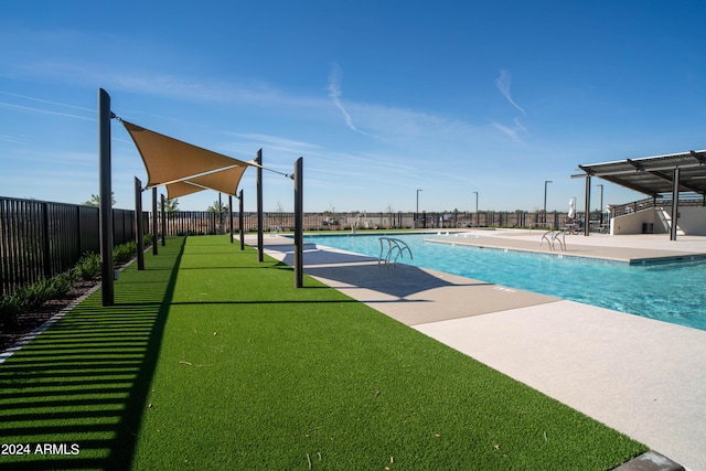 pool with fence and a patio