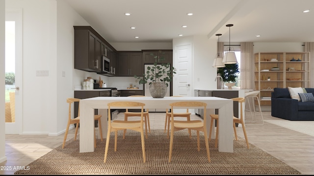 dining area featuring recessed lighting and light wood-style flooring