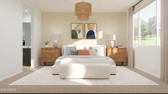 bedroom with baseboards, a sink, carpet, and ensuite bathroom
