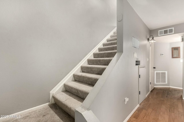 stairway with wood-type flooring