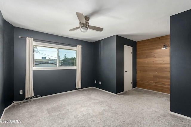 carpeted empty room with ceiling fan