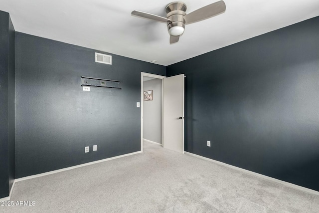 spare room with light colored carpet and ceiling fan