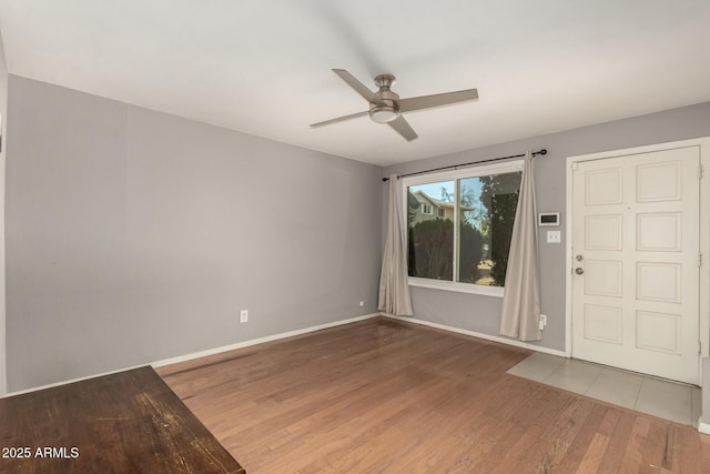 spare room featuring ceiling fan and dark hardwood / wood-style flooring