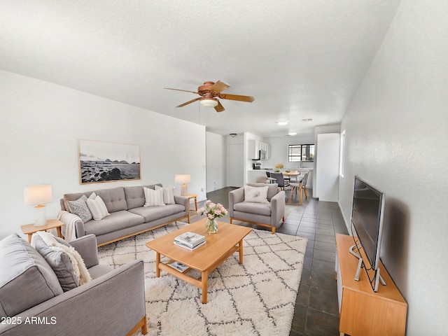 tiled living room featuring ceiling fan