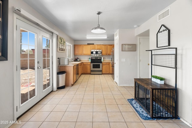 1374 E 10th Pl, Casa Grande, AZ 85122 - kitchen featuring appliances with stainless steel finishes, light countertops, french doors, and light tile patterned flooring