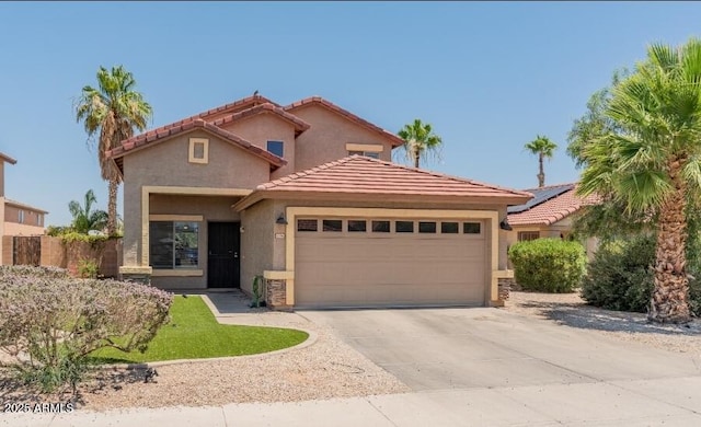 1374 E 10th Pl, Casa Grande, AZ 85122 - mediterranean / spanish-style home featuring stucco siding, a tiled roof, a garage, and driveway